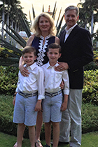 Dr. Huger smiles with her husband and twin boys